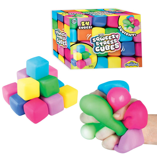Colorful squishy stress cubes with packaging and a hand holding a cube.
