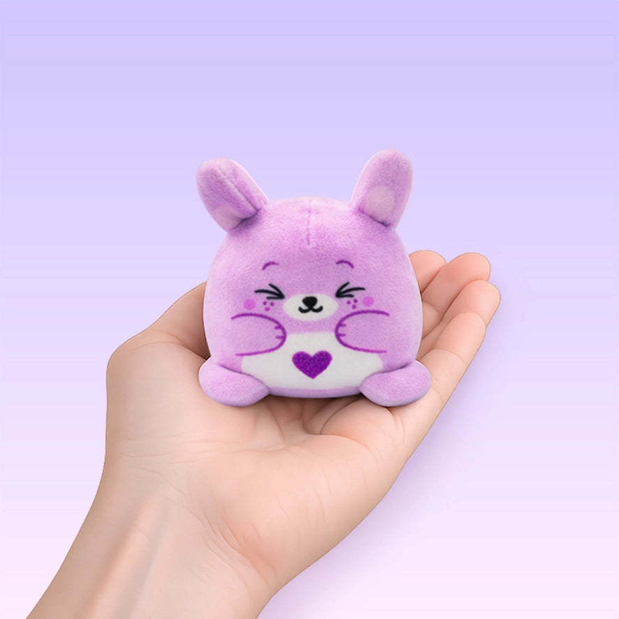 Purple plush toy with a heart on a light purple background