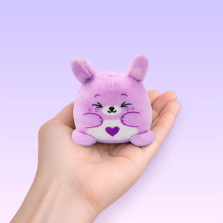Purple plush toy with a heart on a light purple background