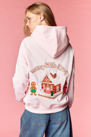 Back view of pink hoodie with gingerbread house embroidery and Merry Little Thing text