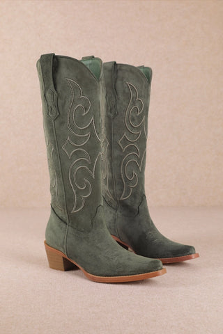 Green suede cowgirl boots with embroidered scrollwork design and stacked heel